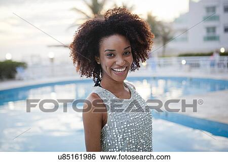 Stock Photograph - "Portrait of stylish young woman at hotel poolside, Rio De Janeiro, Brazil". Fotosearch