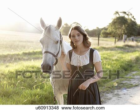 Stock Photo - Portrait of teenage girl and her grey horse. Fotosearch
