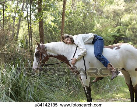 Portrait of teenage girl hugging horse whilst bareback riding View Large Photo Image Stock Photography - Portrait of teenage girl hugging horse whilst bareback riding. Fotosearch