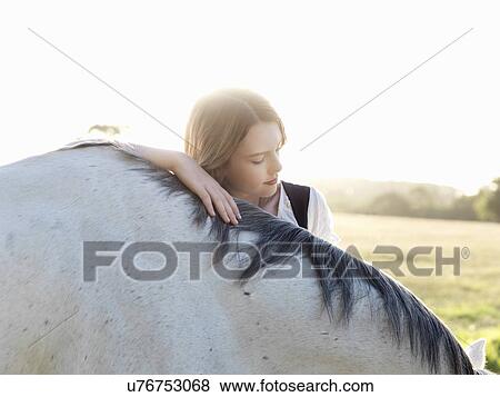 Portrait of teenage girl with grey horse View Large Photo Image Stock Photo - Portrait of teenage girl with grey horse. Fotosearch