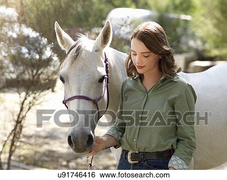 Portrait of teenage girl with grey horse on farm View Large Photo Image Stock Photograph - Portrait of teenage girl with grey horse on farm. Fotosearch