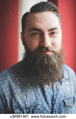 Stock Image - Portrait of young bearded man. Fotosearch