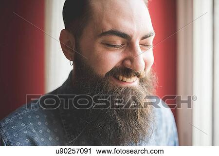 Stock Image - Portrait of young bearded man. Fotosearch