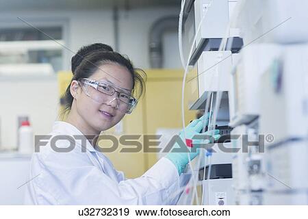 Portrait of young female scientist using scientific equipment in lab View Large Photo Image Stock Photo - Portrait of young female scientist using scientific equipment in lab. Fotosearch