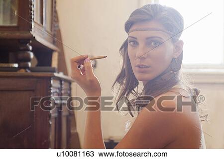 "Portrait of young woman, applying eye pencil" View Large Photo Image Stock Image - "Portrait of young woman, applying eye pencil". Fotosearch