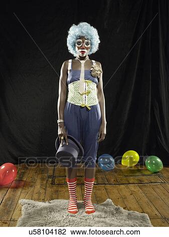 Portrait of young woman wearing clown face paint and blue wig on stage View Large Photo Image Stock Image - Portrait of young woman wearing clown face paint and blue wig on stage. Fotosearch