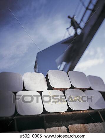 "Raw steel in storage facility with worker looking down from gantry, low angle view" View Large Photo Image Stock Photography - "Raw steel in storage facility with worker looking down from gantry, low angle view". Fotosearch