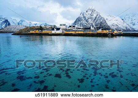 Stock Photo - "Reine fishing village with snow capped mountains, Norway". Fotosearch
