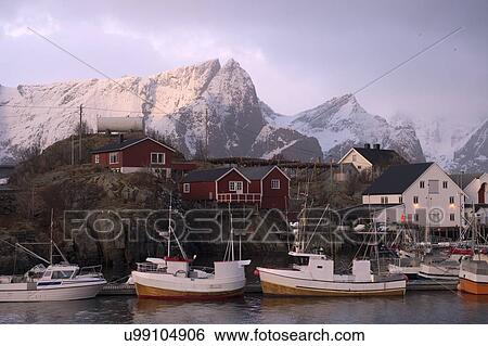 Stock Photograph - "Reine fishing village with snow capped mountains, Norway". Fotosearch