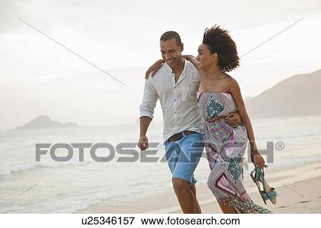 "Romantic couple strolling on beach, Rio De Janeiro, Brazil" View Large Photo Image Stock Photo - "Romantic couple strolling on beach, Rio De Janeiro, Brazil". Fotosearch
