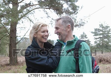 Stock Photo - Romantic hiking couple walking in woods. Fotosearch