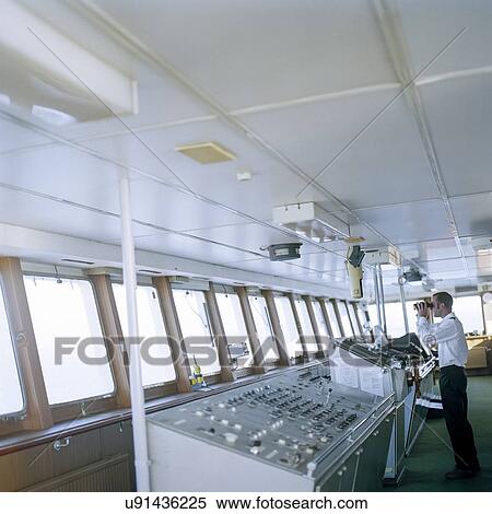 Sailor using binoculars on bridge of container ship at sea View Large Photo Image Stock Photography - Sailor using binoculars on bridge of container ship at sea. Fotosearch