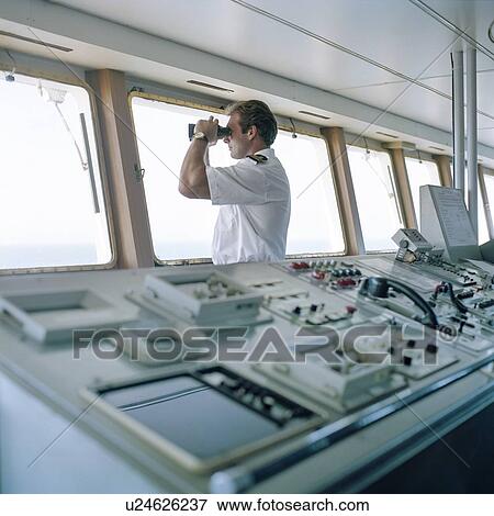 Sailor using binoculars on container ship at sea View Large Photo Image Stock Photo - Sailor using binoculars on container ship at sea. Fotosearch