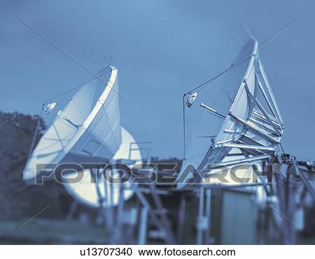 Satellite dish receivers against cloudy sky View Large Photo Image Stock Image - Satellite dish receivers against cloudy sky. Fotosearch