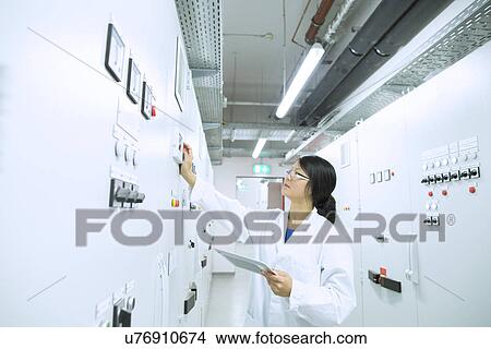 Scientist in control room View Large Photo Image Picture - Scientist in control room. Fotosearch