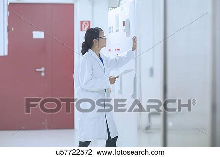 Stock Image - Scientist in control room. Fotosearch
