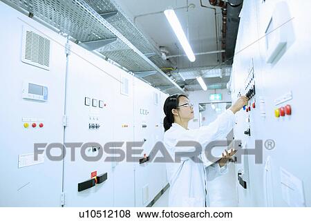 Scientist in control room View Large Photo Image Stock Photo - Scientist in control room. Fotosearch