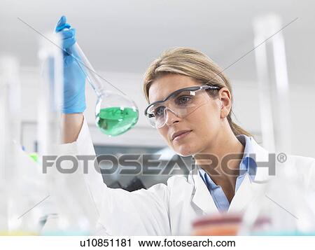 Scientist viewing chemical experiment in a laboratory View Large Photo Image Stock Image - Scientist viewing chemical experiment in a laboratory. Fotosearch