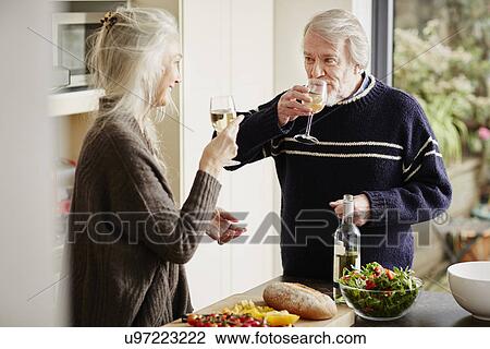 Senior couple drinking wine in kitchen View Large Photo Image Stock Image - Senior couple drinking wine in kitchen. Fotosearch