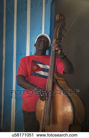 "Senior man playing double bass in front of blue wall, Santiago de Cuba, Cuba" View Large Photo Image Stock Image - "Senior man playing double bass in front of blue wall, Santiago de Cuba, Cuba". Fotosearch