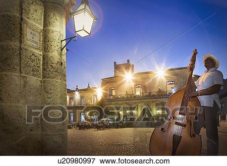 "Senior man playing double bass in Plaza de la Cathedral at night, Havana, Cuba" View Large Photo Image Stock Photo - "Senior man playing double bass in Plaza de la Cathedral at night, Havana, Cuba". Fotosearch