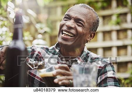 "Senior man pouring beer, laughing" View Large Photo Image Stock Photo - "Senior man pouring beer, laughing". Fotosearch
