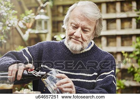 Senior man pouring beer View Large Photo Image Stock Image - Senior man pouring beer. Fotosearch
