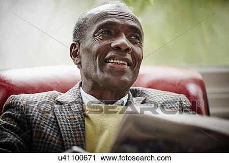 Stock Image - Senior man reading newspaper. Fotosearch