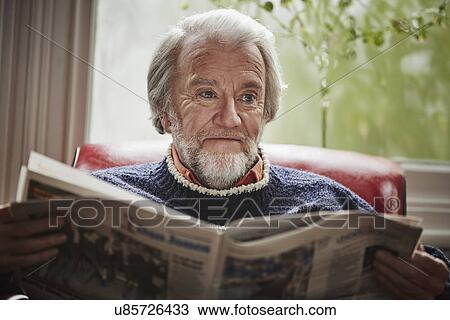 Stock Image - Senior man reading newspaper. Fotosearch