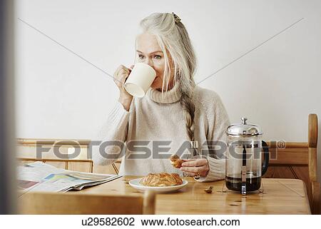 Senior woman drinking coffee at breakfast View Large Photo Image Stock Image - Senior woman drinking coffee at breakfast. Fotosearch