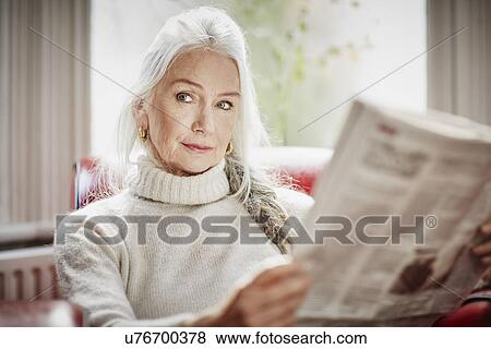 Senior woman reading newspaper View Large Photo Image Stock Photo - Senior woman reading newspaper. Fotosearch