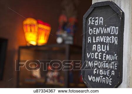 Stock Photo - "Sign welcoming customers, outside shop, close-up". Fotosearch