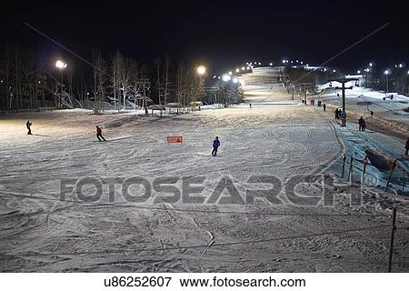 "Skiers skiing down ski slope at night, Hemavan, Sweden" View Large Photo Image Stock Photo - "Skiers skiing down ski slope at night, Hemavan, Sweden". Fotosearch