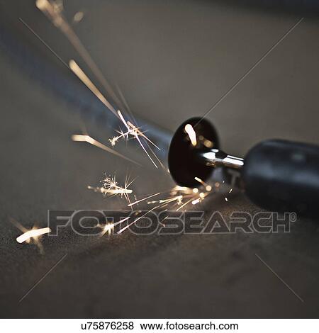 Stock Photo - "Small disc cutter creating sparks, close-up". Fotosearch