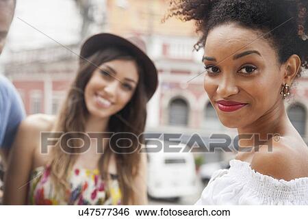 Stock Photograph - "Small group of friends, looking at camera, smiling". Fotosearch