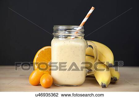 "Still life of fresh banana, orange and kumquat smoothie" View Large Photo Image Stock Image - "Still life of fresh banana, orange and kumquat smoothie". Fotosearch