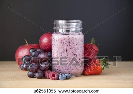 Stock Photography - "Still life of fresh grape, apple and berry smoothie". Fotosearch