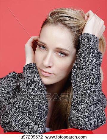 Stock Image - Studio portrait of a blond mid adult woman smiling at camera. Fotosearch