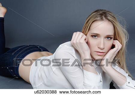 Studio portrait of a blond mid adult woman laying down smiling at camera View Large Photo Image Stock Photo - Studio portrait of a blond mid adult woman laying down smiling at camera. Fotosearch
