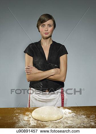 Studio portrait of young woman baking bread dough View Large Photo Image Stock Photo - Studio portrait of young woman baking bread dough. Fotosearch