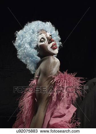 Studio portrait of young woman in clown face paint wrapped in pink feather boa View Large Photo Image Stock Image - Studio portrait of young woman in clown face paint wrapped in pink feather boa. Fotosearch
