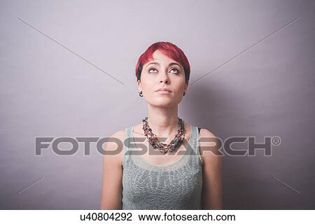 Studio portrait of young woman with short pink hair looking up View Large Photo Image Stock Image - Studio portrait of young woman with short pink hair looking up. Fotosearch