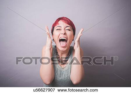 Studio portrait of young woman with short pink hair laughing View Large Photo Image Stock Photo - Studio portrait of young woman with short pink hair laughing. Fotosearch