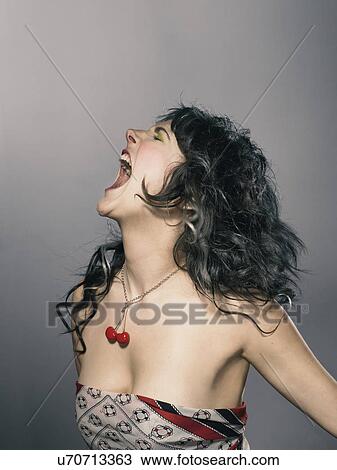 Studio shot of young woman shouting View Large Photo Image Stock Image - Studio shot of young woman shouting. Fotosearch
