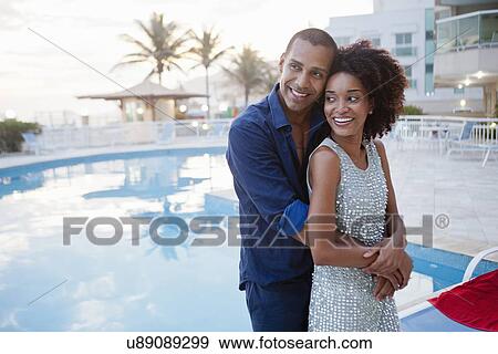 "Stylish couple hugging at hotel poolside, Rio De Janeiro, Brazil" View Large Photo Image Stock Photo - "Stylish couple hugging at hotel poolside, Rio De Janeiro, Brazil". Fotosearch