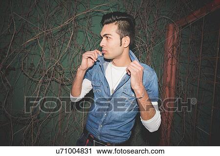 Stylish young man holding collar View Large Photo Image Stock Image - Stylish young man holding collar. Fotosearch