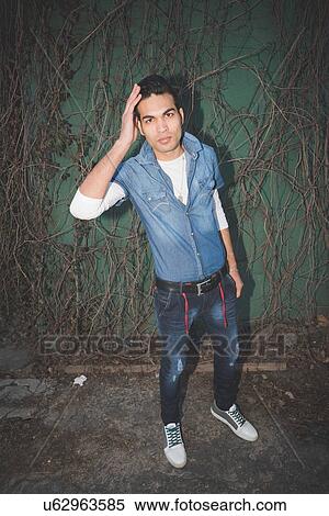 Stylish young man with hand in hair View Large Photo Image Stock Photography - Stylish young man with hand in hair. Fotosearch