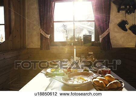 Sunlit breakfast table in log cabin View Large Photo Image Stock Image - Sunlit breakfast table in log cabin. Fotosearch