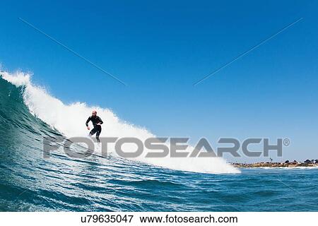 "Surfer riding waves in ocean, California, USA" View Large Photo Image Stock Photo - "Surfer riding waves in ocean, California, USA". Fotosearch