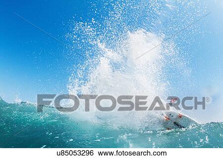 Stock Photograph - "Surfer riding waves in ocean, California, USA". Fotosearch